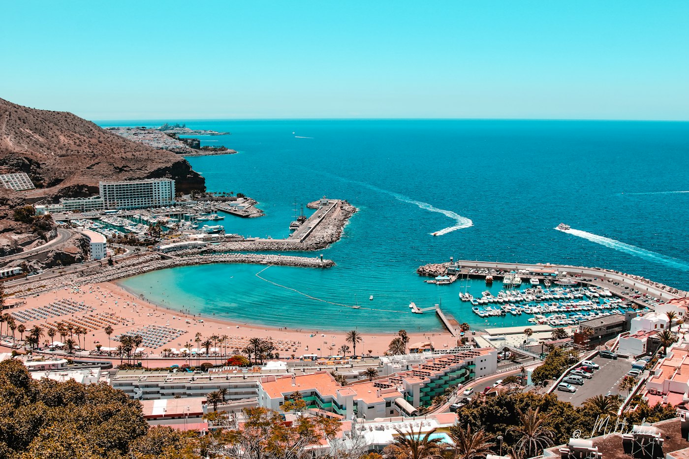 A marina and a turquoise bay from above on the south-west coast of Gran Canaria